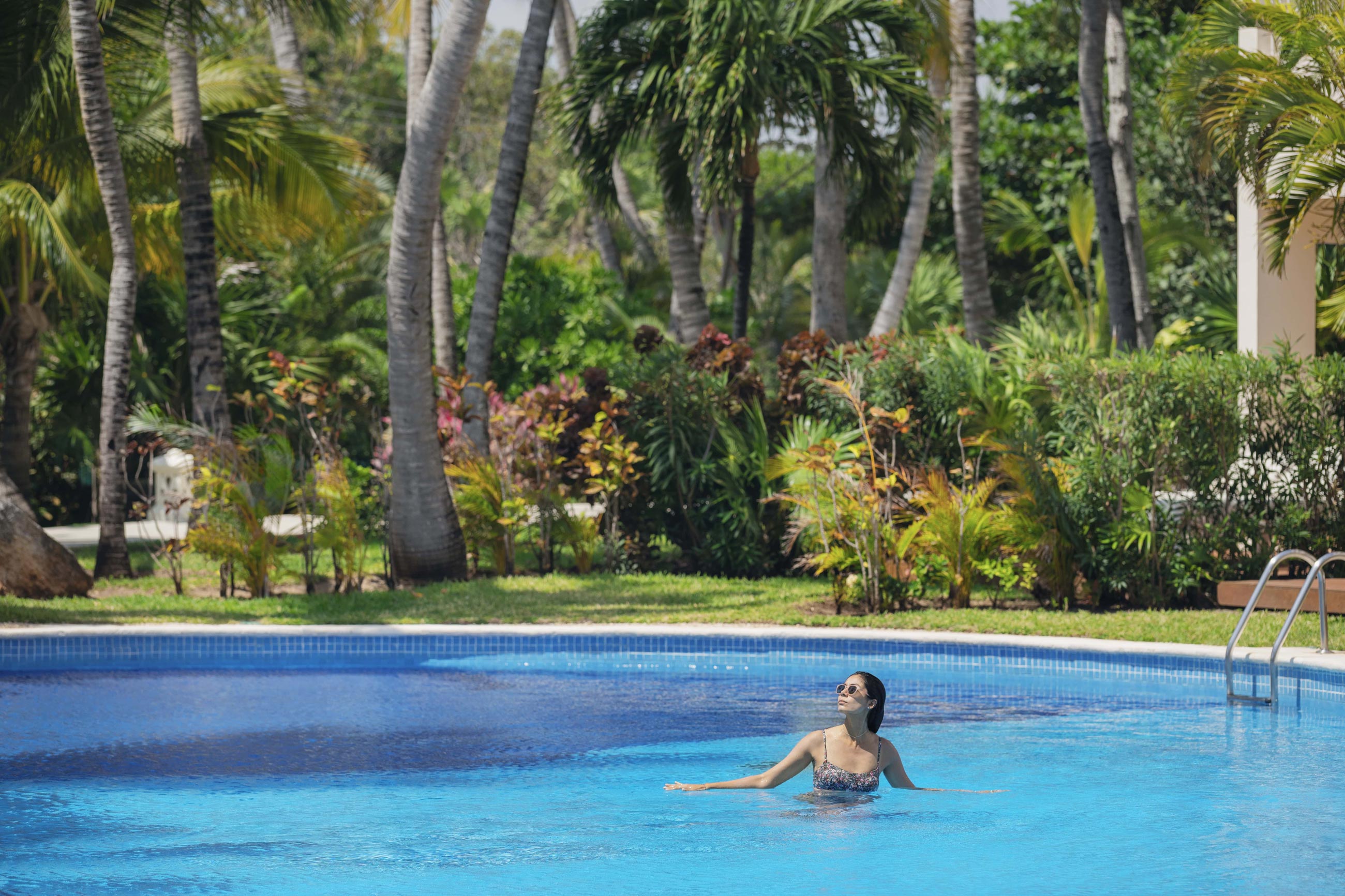 Happy female traveller alone in a Cancun resort