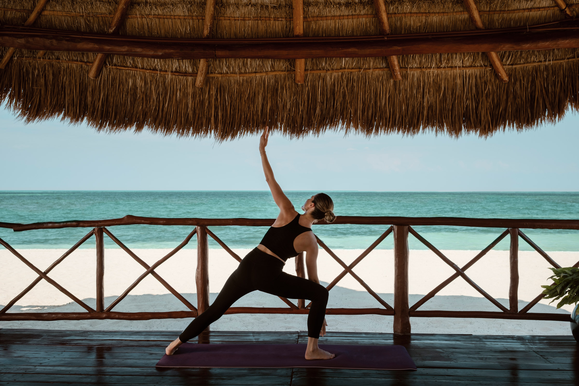 Woman joining a Yoga class in her resort in Cancun