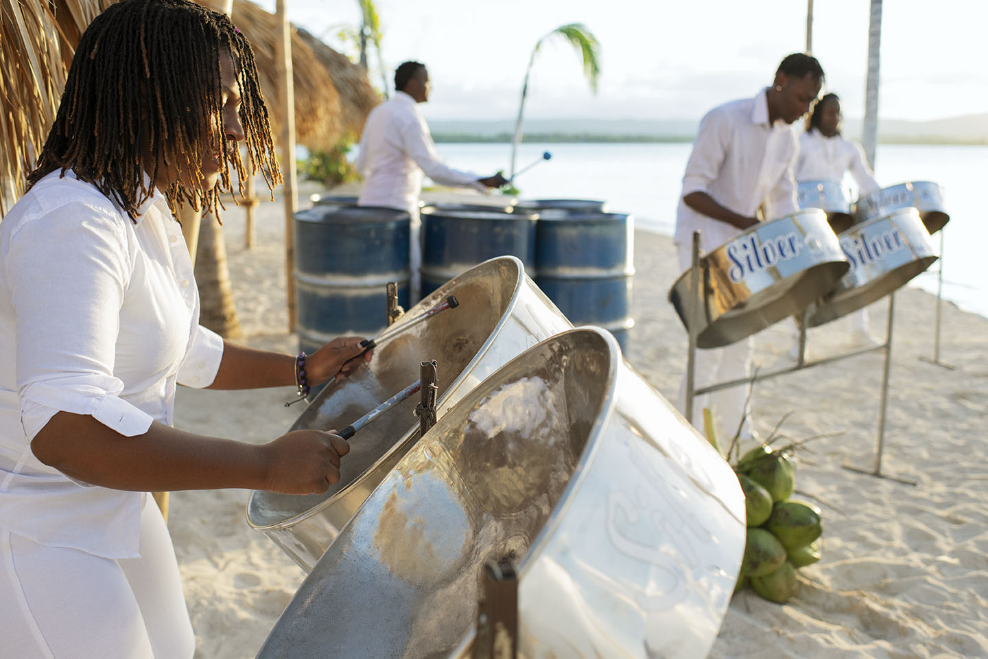 Woman playing drums in the tropical destination of Jamaica Woman playing drums in the tropical destination of Jamaica