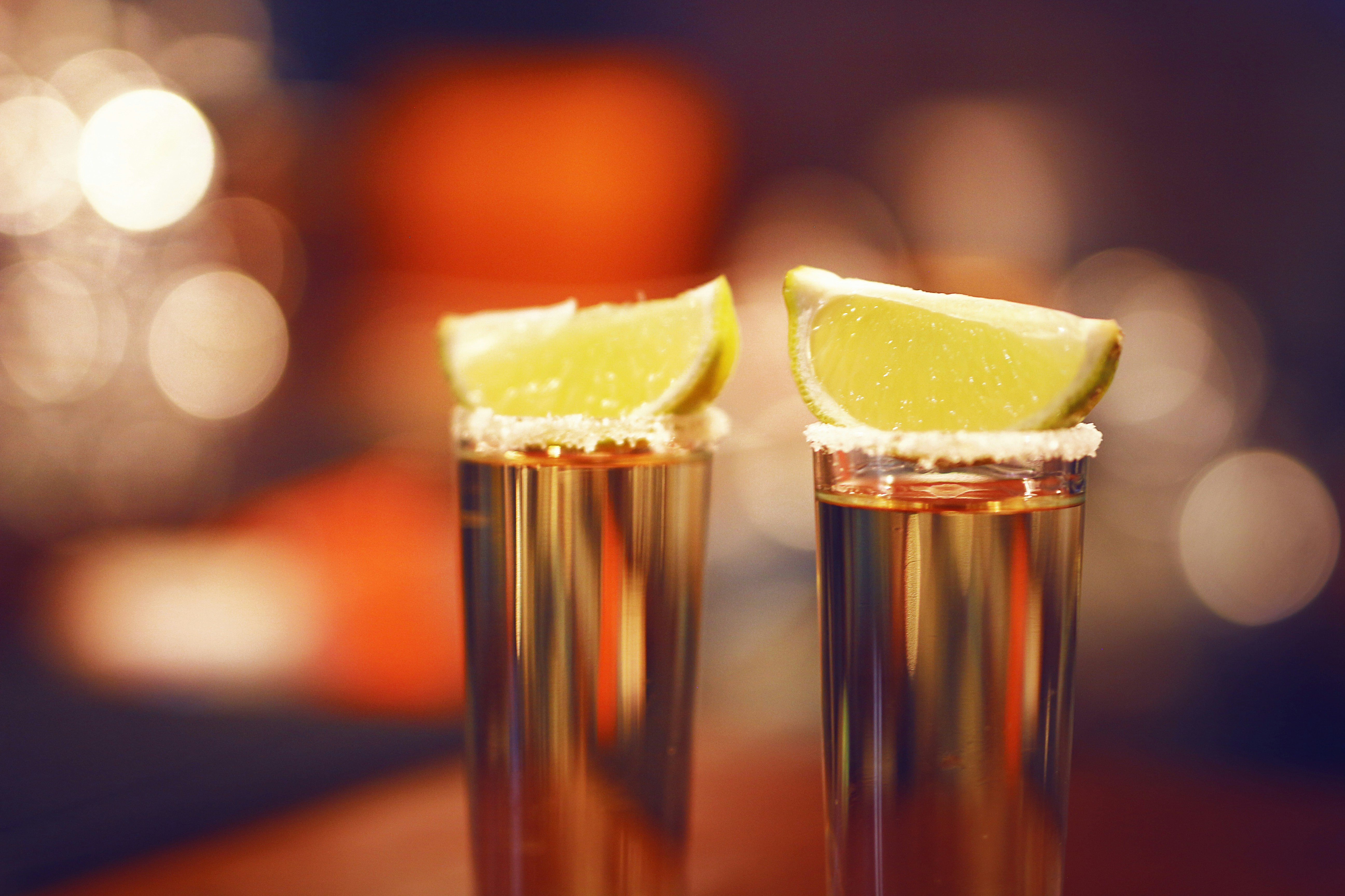 Tequila shots on vacation with a wedge of lime Tequila shots on vacation with a wedge of lime