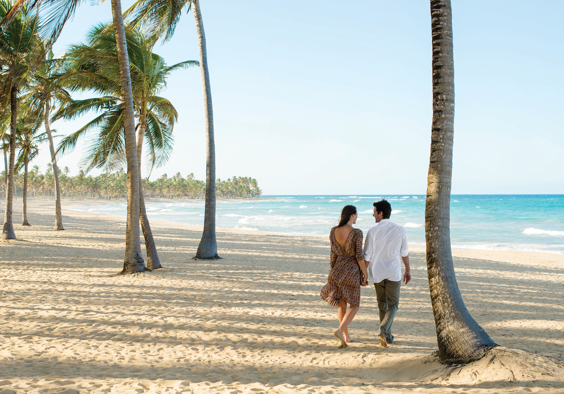 Couple walking along the beach in Excellence Punta Cana